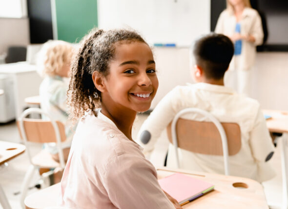 African-american young smart schoolgirl pupil attending school lesson class listening to teacher