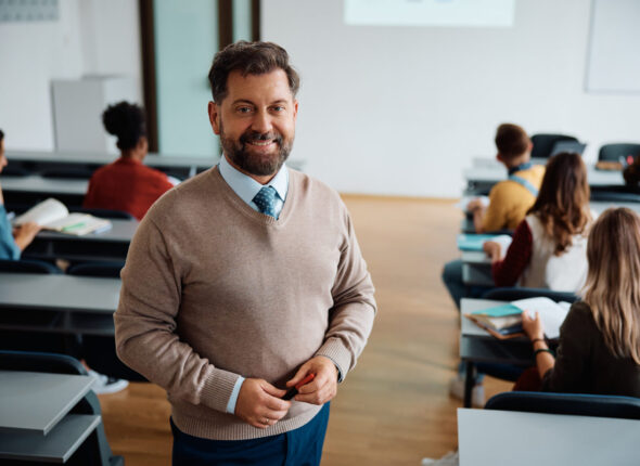 Portrait of happy university teacher during a class looking at camera.