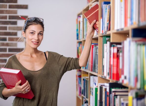 young-woman-wearing-glasses-take-a-book-from-shelf-2021-08-29-09-41-48-utc-2048x1365